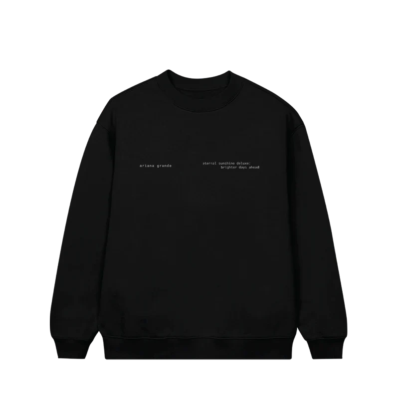 Black Ariana Grande crewneck sweatshirt featuring minimalist white text on the front left chest that reads “ariana grande” and “eternal sunshine deluxe: brighter days ahead.” A subtle and sleek design perfect for fans of the Eternal Sunshine era.