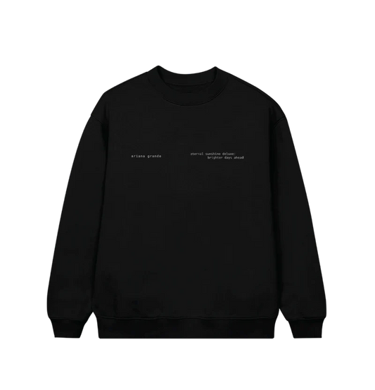 Black Ariana Grande crewneck sweatshirt featuring minimalist white text on the front left chest that reads “ariana grande” and “eternal sunshine deluxe: brighter days ahead.” A subtle and sleek design perfect for fans of the Eternal Sunshine era.