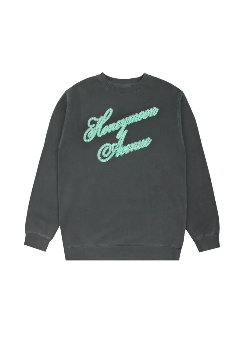 Washed black crewneck sweatshirt featuring 'Honeymoon Avenue' in large mint green cursive embroidery across the chest. A cozy tribute to Ariana Grande's Yours Truly 10th Anniversary collection.