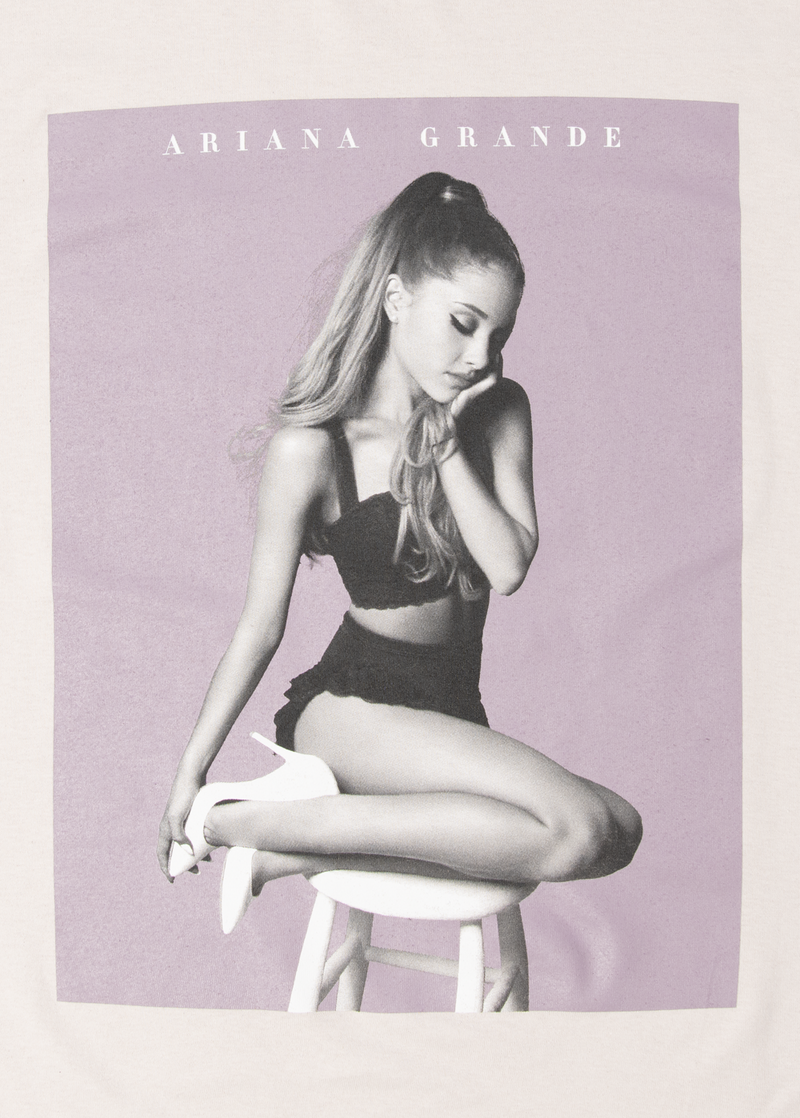 Close-up of the Ariana Grande My Everything lilac poster graphic printed on a cream t-shirt, with Ariana in a pensive pose over soft purple tones and white text reading “Ariana Grande.”