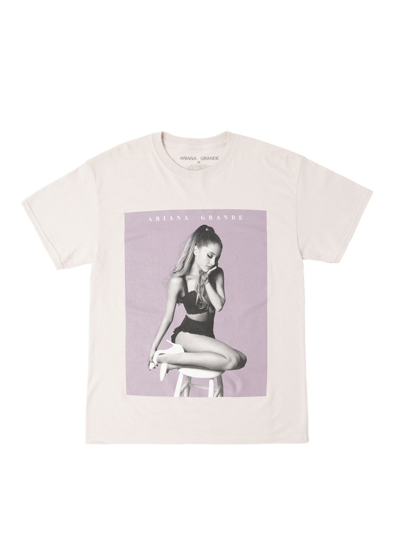 Off-white Ariana Grande t-shirt featuring the My Everything album artwork with a lilac background, showing Ariana seated on a stool in a matching black crop top and skirt set.