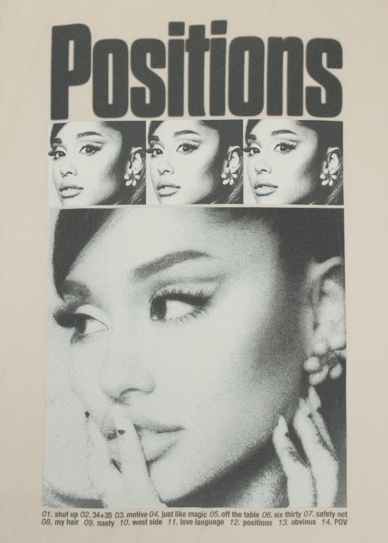 Close-up of Ariana Grande’s photo print on off-white 'Positions' t-shirt, with retro film grain styling and a typewritten tracklist including songs like 'shut up,' '34+35,' and 'love language.'