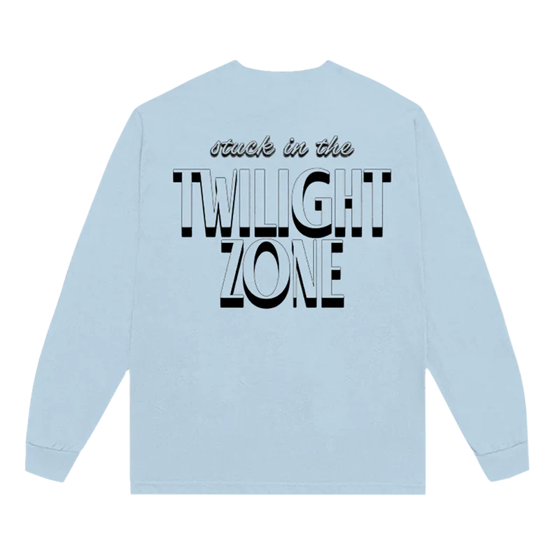 Back of Ariana Grande’s Twilight Zone long sleeve shirt in light blue, featuring bold black-and-white text that reads “stuck in the TWILIGHT ZONE.”