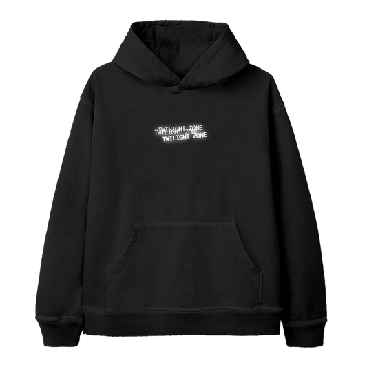 Black Ariana Grande hoodie featuring a minimalist “Twilight Zone” text design in white, stacked and slightly staggered across the chest — part of the official Twilight Zone merch collection.