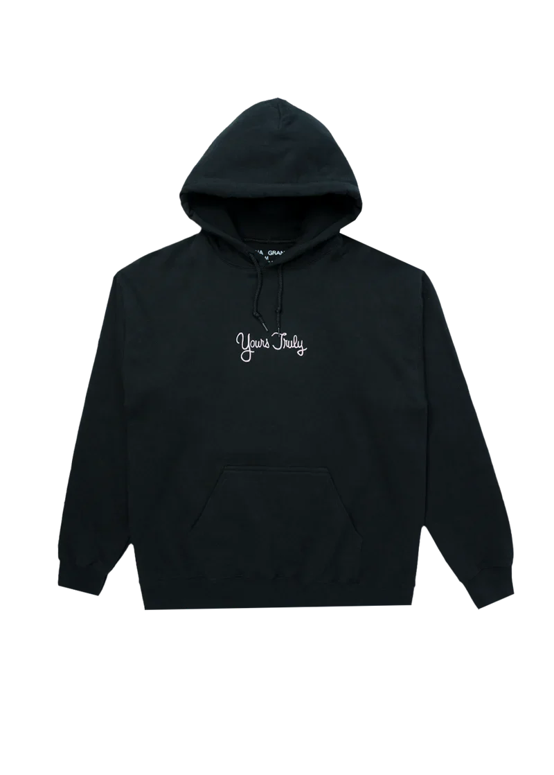 Black Ariana Grande hoodie with 'Yours Truly' embroidered in white cursive text on the chest. Simple and classic design inspired by her debut album aesthetic.