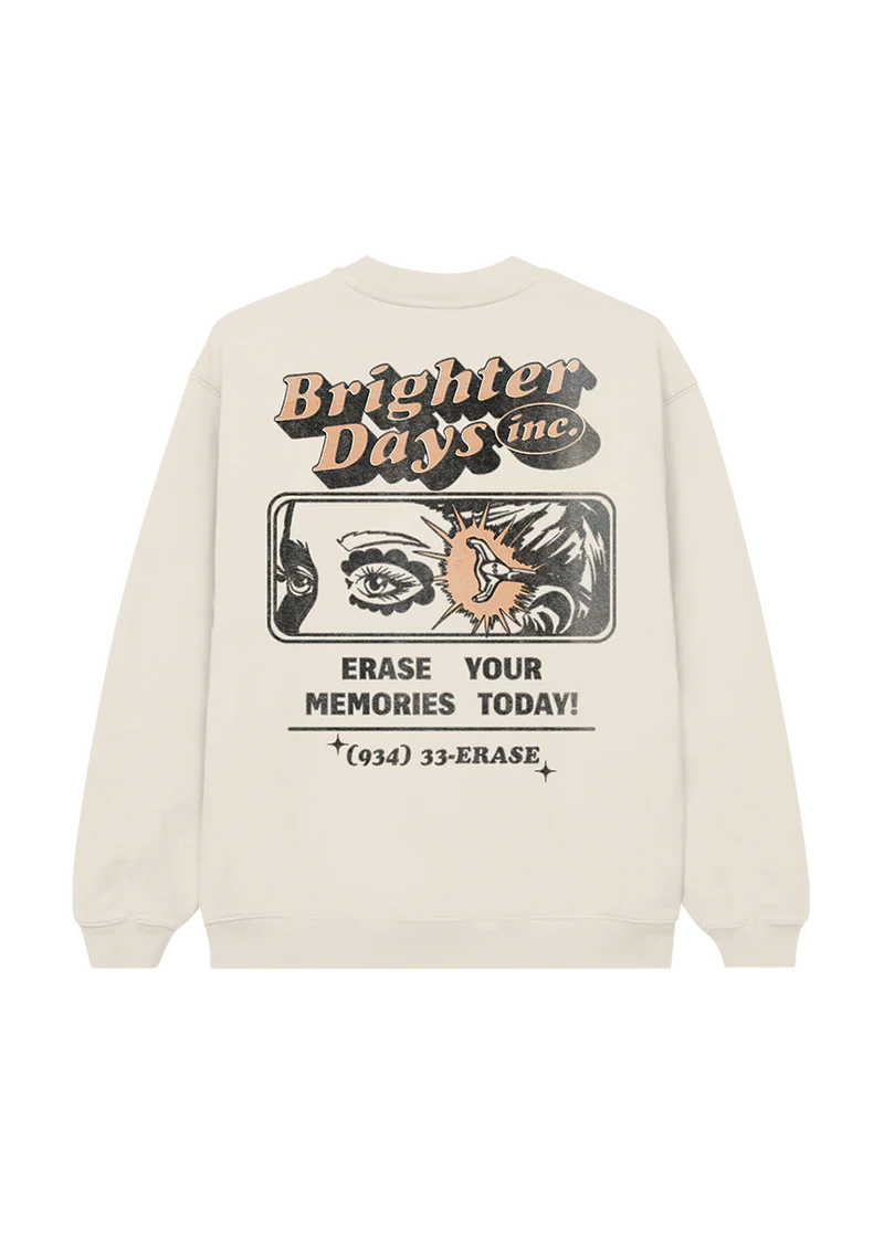 Back of cream crewneck featuring a bold comic-style “Brighter Days Inc.” ad design with an eye illustration, lightning bolt, and the text: “Erase Your Memories Today! (934) 33-ERASE” — nostalgic sci-fi vibes meet eternal sunshine aesthetic.