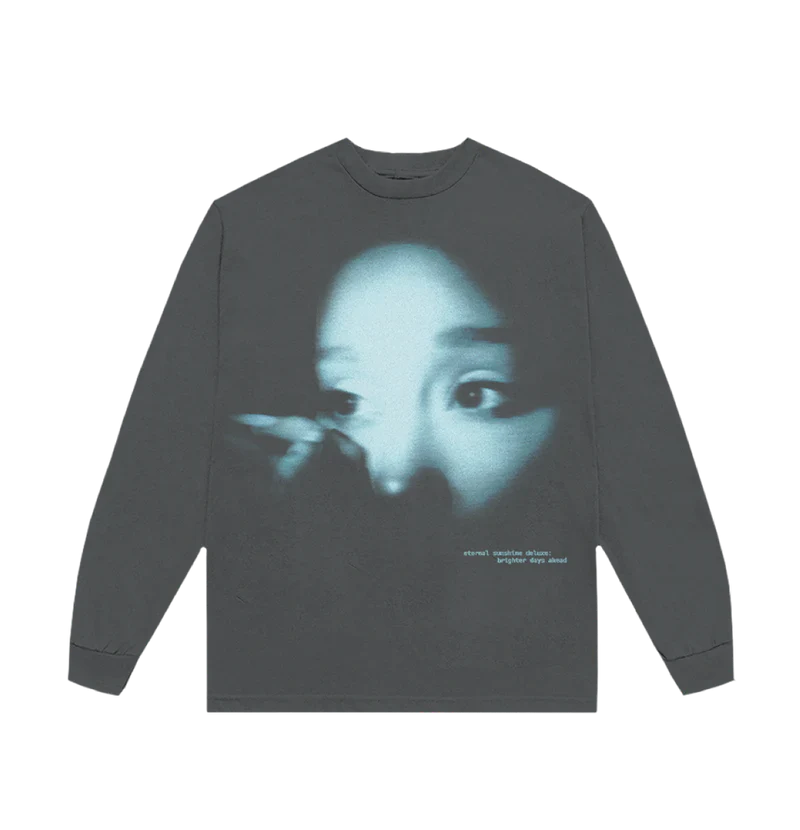 Dark long sleeve t-shirt featuring a blue-tinted close-up photo of Ariana Grande’s face with the text “eternal sunshine deluxe: brighter days ahead” printed in lowercase white on the bottom right.