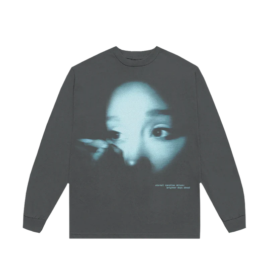 Dark long sleeve t-shirt featuring a blue-tinted close-up photo of Ariana Grande’s face with the text “eternal sunshine deluxe: brighter days ahead” printed in lowercase white on the bottom right.