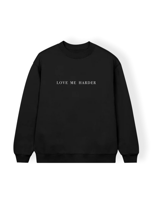 Black crewneck sweatshirt with centered white serif text reading “LOVE ME HARDER” — minimalist design inspired by Ariana Grande’s hit duet from the My Everything era.