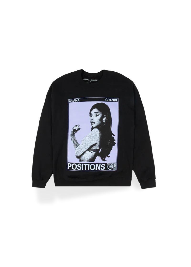 Black Ariana Grande crewneck sweatshirt featuring a large graphic of Ariana in a vintage photo booth style with bold white text reading “POSITIONS.” A striking pop art–inspired design that captures the aesthetic of her Positions era.