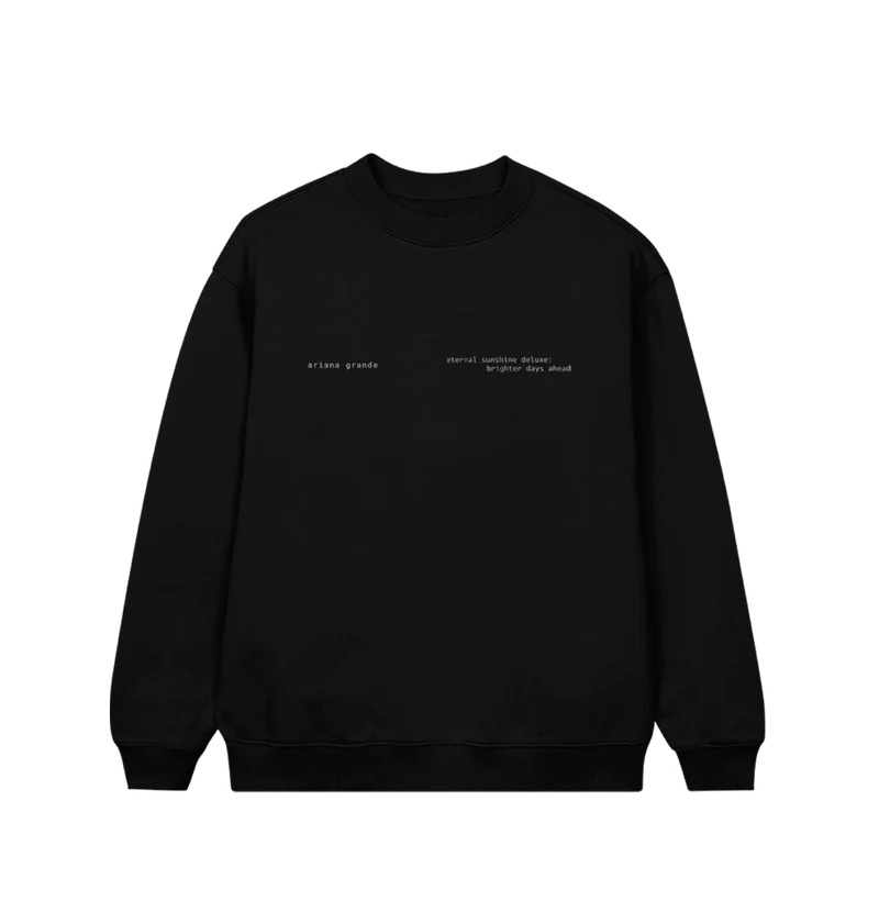 Black Ariana Grande crewneck sweatshirt featuring minimalist white text on the front left chest that reads “ariana grande” and “eternal sunshine deluxe: brighter days ahead.” A subtle and sleek design perfect for fans of the Eternal Sunshine era.

