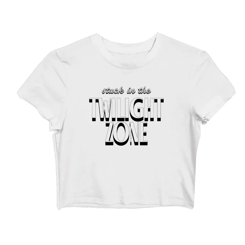White Ariana Grande baby tee with bold black-and-white retro text that says “stuck in the TWILIGHT ZONE” across the front — cropped fit from the official Twilight Zone merch line.

