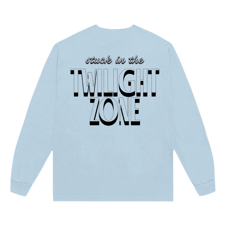 Back of Ariana Grande’s Twilight Zone long sleeve shirt in light blue, featuring bold black-and-white text that reads “stuck in the TWILIGHT ZONE.”

