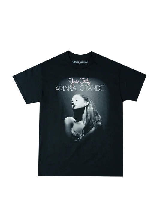 Black Ariana Grande t-shirt featuring the iconic Yours Truly album cover with a spotlighted black-and-white portrait of Ariana and pink-and-white text reading “Yours Truly Ariana Grande.”

