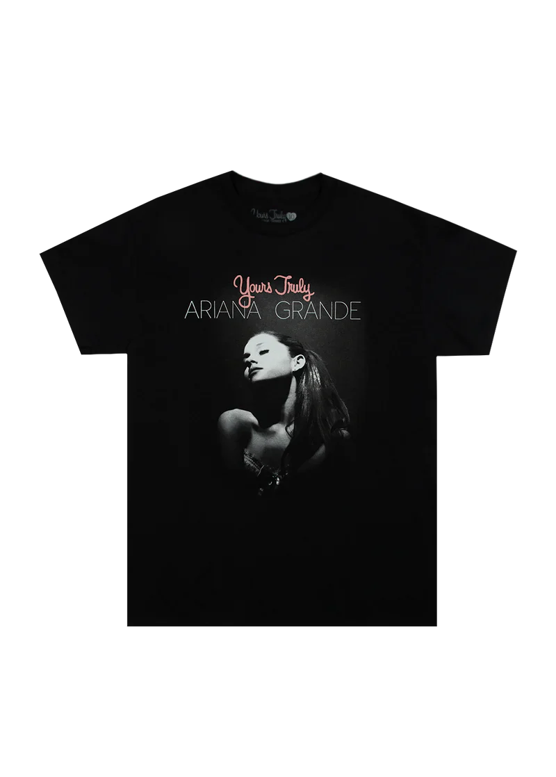 Black Ariana Grande t-shirt with a puff print design featuring a grayscale portrait of Ariana and the text 'Yours Truly Ariana Grande' above the image. A bold tribute to her debut album's 10th anniversary.