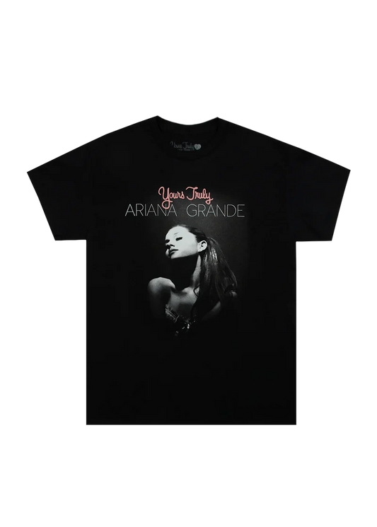 Black Ariana Grande t-shirt with a puff print design featuring a grayscale portrait of Ariana and the text 'Yours Truly Ariana Grande' above the image. A bold tribute to her debut album's 10th anniversary.