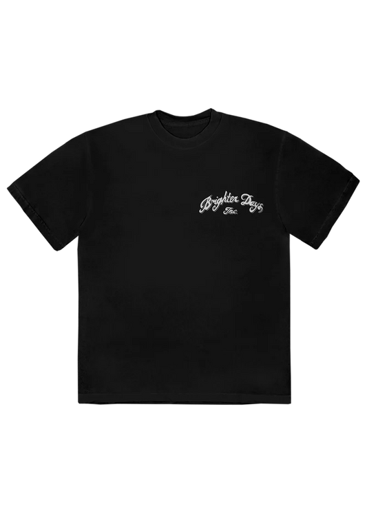 Black Ariana Grande t-shirt with a small vintage-style white script reading “Brighter Days Inc.” on the front left chest. A clean and classic look with a subtle nod to the Eternal Sunshine era.


