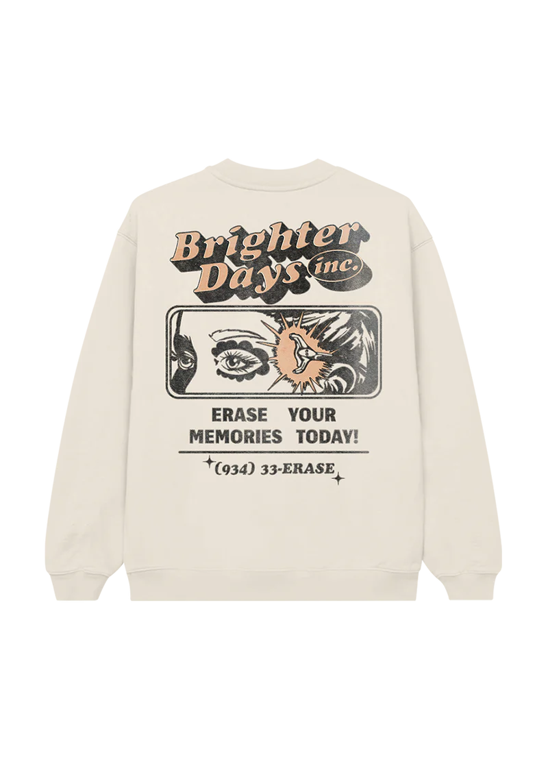 Back of cream crewneck featuring a bold comic-style “Brighter Days Inc.” ad design with an eye illustration, lightning bolt, and the text: “Erase Your Memories Today! (934) 33-ERASE” — nostalgic sci-fi vibes meet eternal sunshine aesthetic.

