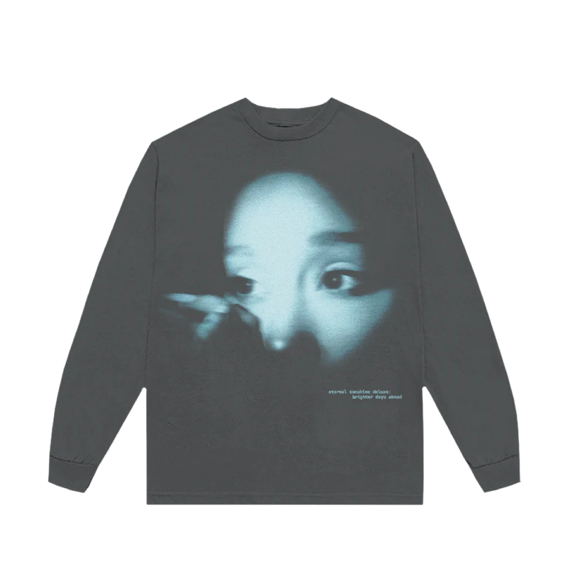 Dark long sleeve t-shirt featuring a blue-tinted close-up photo of Ariana Grande’s face with the text “eternal sunshine deluxe: brighter days ahead” printed in lowercase white on the bottom right.

