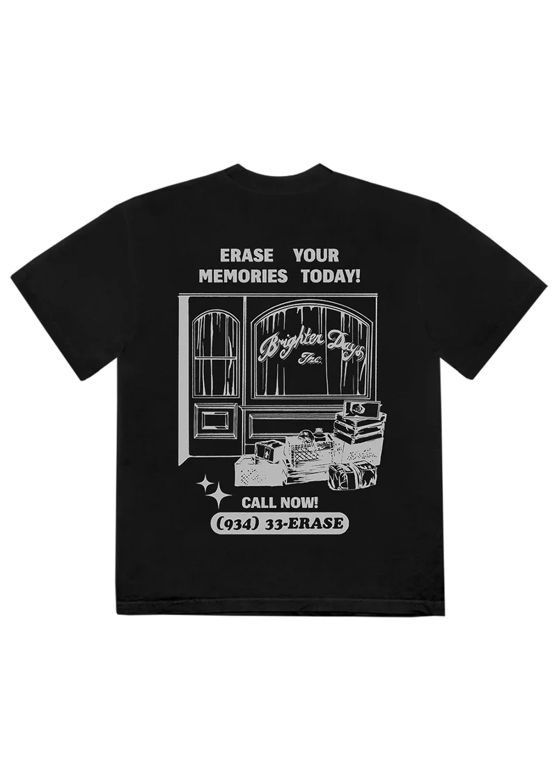 Back of the black Ariana Grande t-shirt featuring a large graphic of a storefront labeled “Brighter Days Inc.” with luggage and text that reads “Erase your memories today!” and “Call now! (934) 33-ERASE.” A bold, nostalgic design inspired by themes of emotional renewal.

