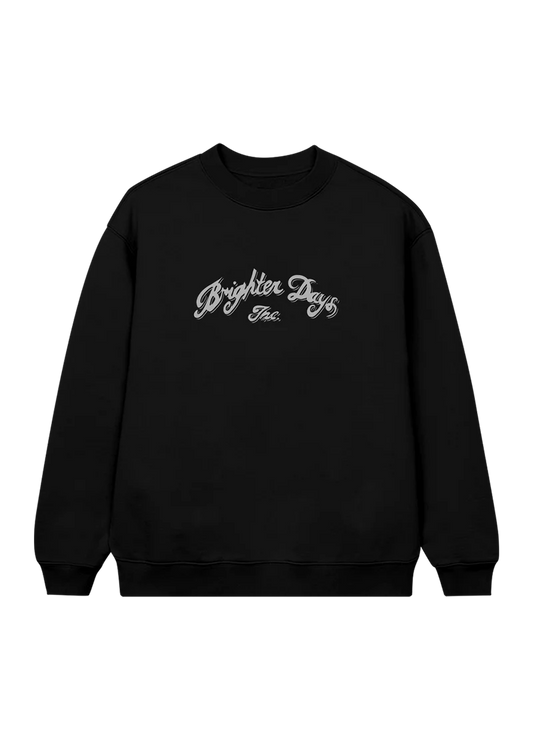 Black crewneck sweatshirt featuring elegant silver script that reads “Brighter Days Inc.” across the chest — minimalist yet vintage-inspired merch from Ariana Grande’s eternal sunshine collection.

