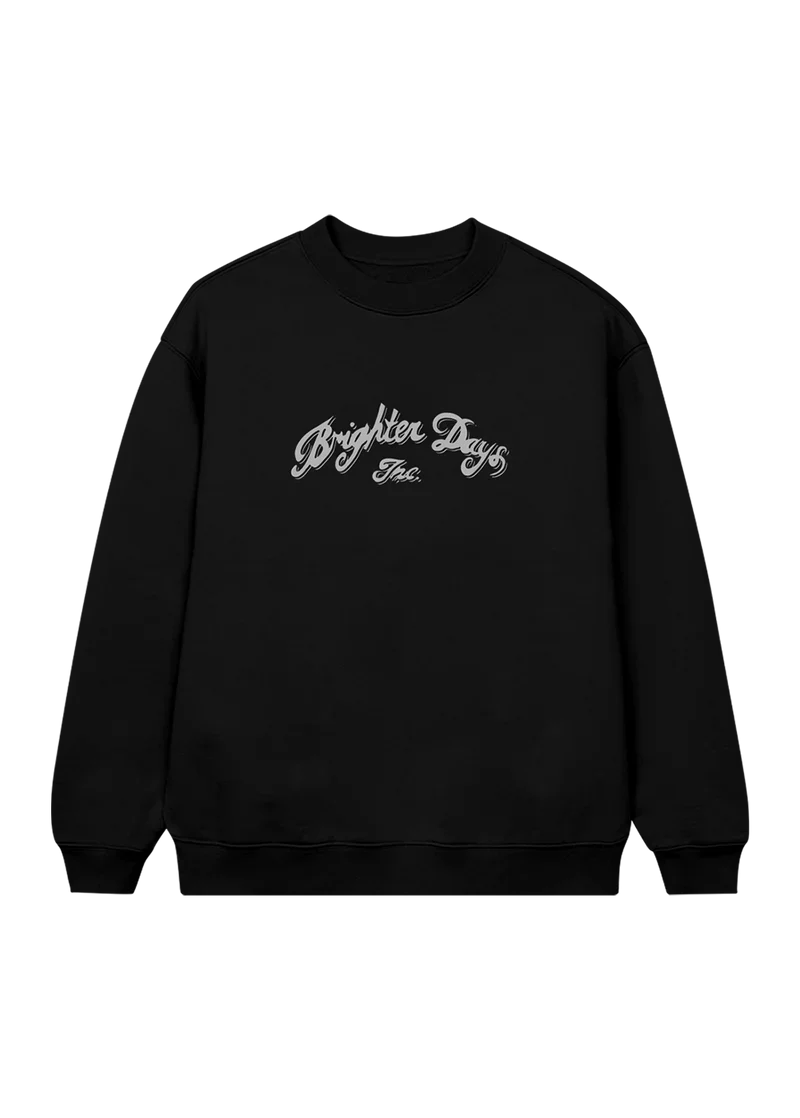 Black crewneck sweatshirt featuring elegant silver script that reads “Brighter Days Inc.” across the chest — minimalist yet vintage-inspired merch from Ariana Grande’s eternal sunshine collection.

