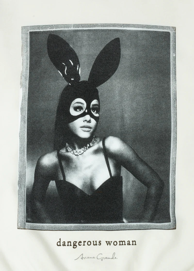 Close-up of Ariana Grande’s Dangerous Woman portrait printed on cream fabric, showcasing her signature bunny mask look with the words “dangerous woman” and her autograph in script.

