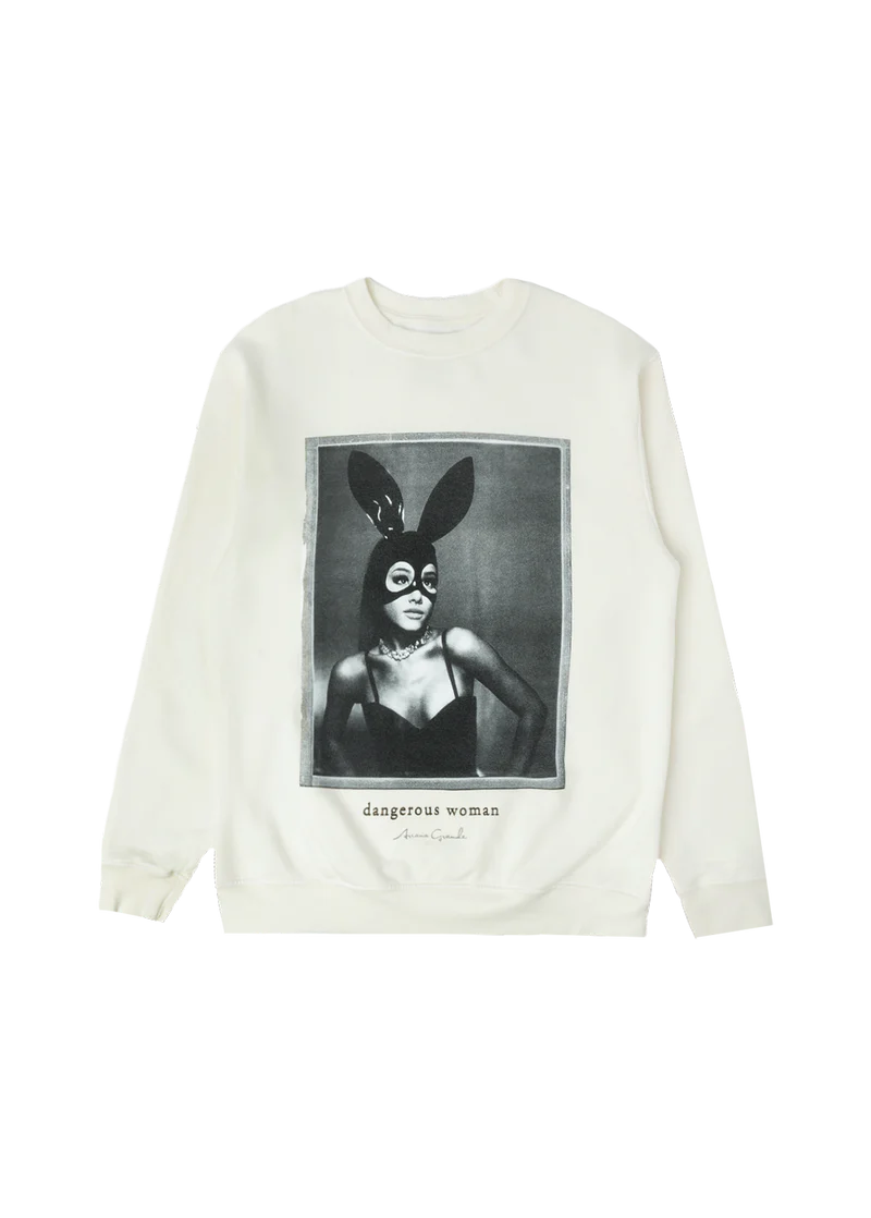 Cream-colored crewneck featuring a bold black-and-white photo of Ariana Grande in her iconic latex bunny mask and black bustier, with “dangerous woman” and her signature printed underneath — classic merch from the Dangerous Woman era.

