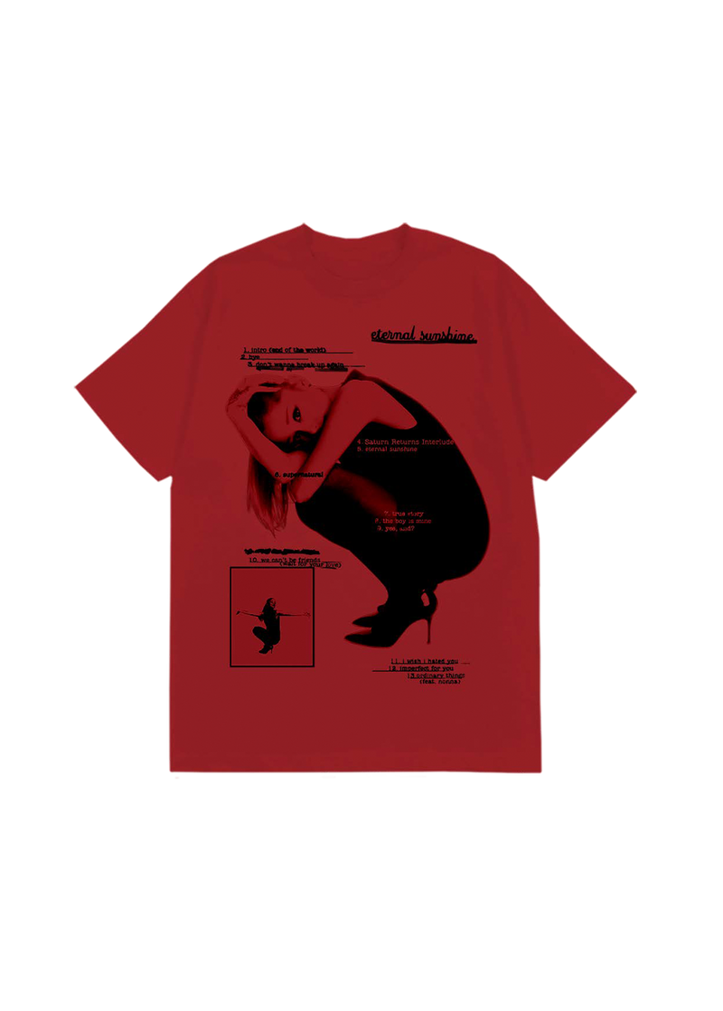 Bright red Ariana Grande t-shirt showcasing a black-and-white photo of Ariana in a crouched pose, overlaid with the complete Eternal Sunshine tracklist in black text. Includes song titles like “eternal sunshine,” “we can’t be friends,” and “ordinary things (feat. nonna),” styled in a raw, editorial layout.

