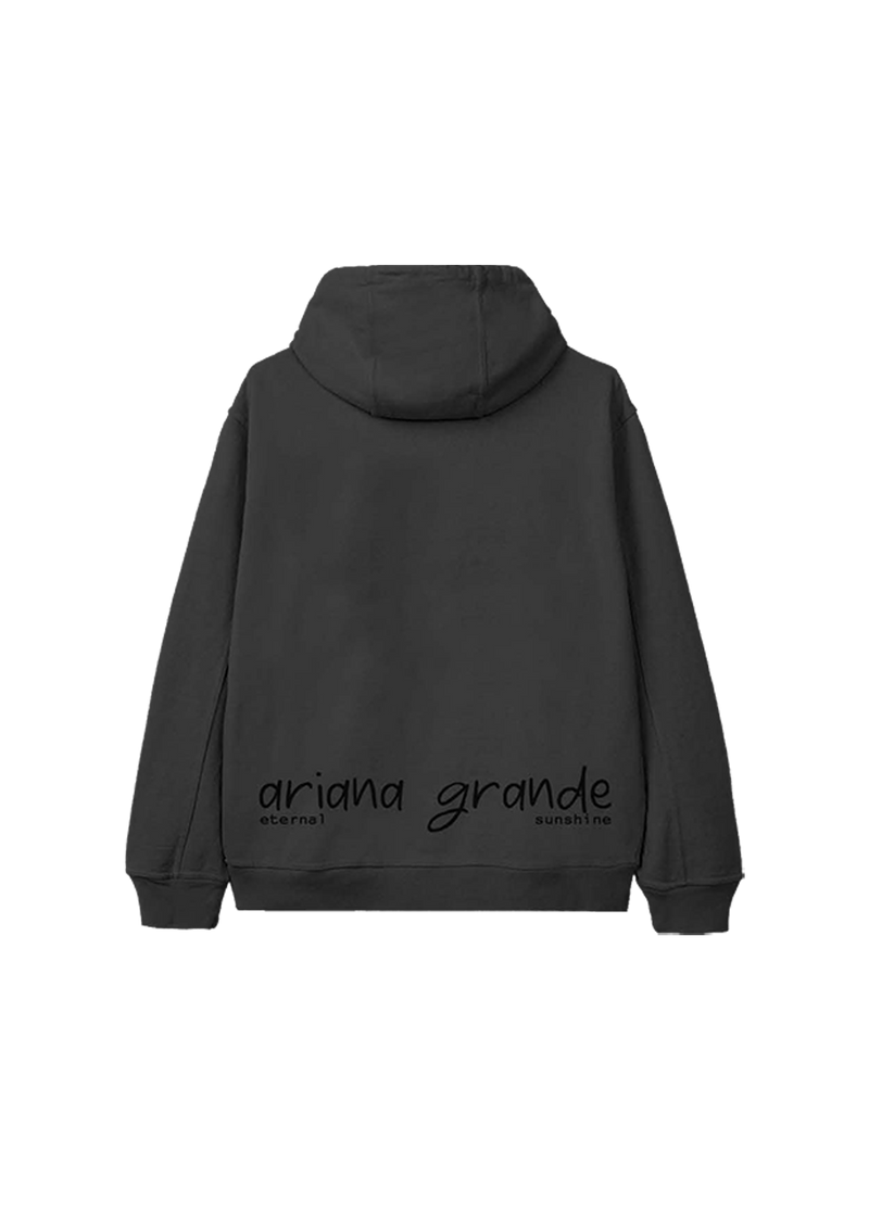 Back of a dark grey hoodie with minimalist black text reading "ariana grande" in handwritten style, and "eternal sunshine" underneath—official merch from Ariana Grande’s "eternal sunshine" era.

