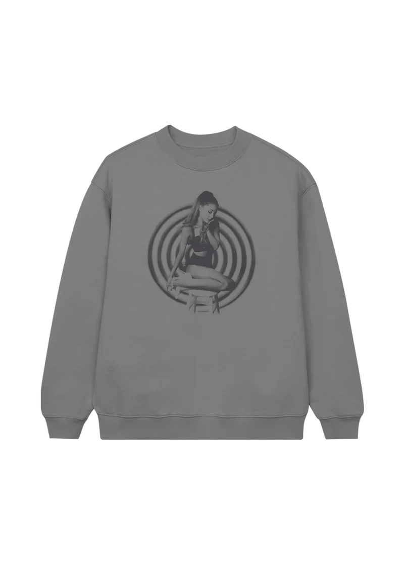 Heather grey crewneck featuring a black-and-white image of Ariana Grande seated in front of hypnotic concentric circles — a retro-styled nod to her My Everything album era.

