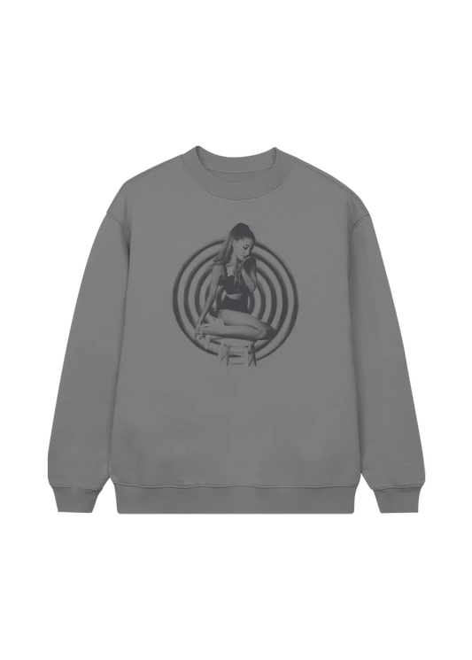 Heather grey crewneck featuring a black-and-white image of Ariana Grande seated in front of hypnotic concentric circles — a retro-styled nod to her My Everything album era.

