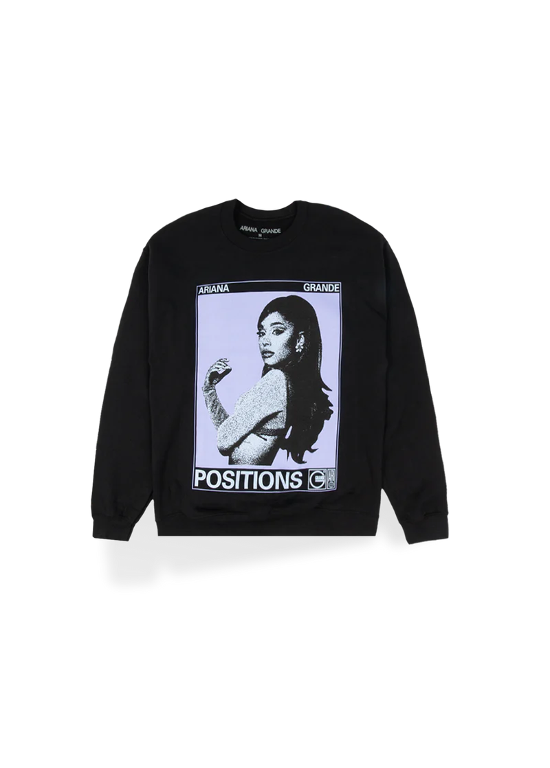 Black Ariana Grande crewneck sweatshirt featuring a large graphic of Ariana in a vintage photo booth style with bold white text reading “POSITIONS.” A striking pop art–inspired design that captures the aesthetic of her Positions era.

