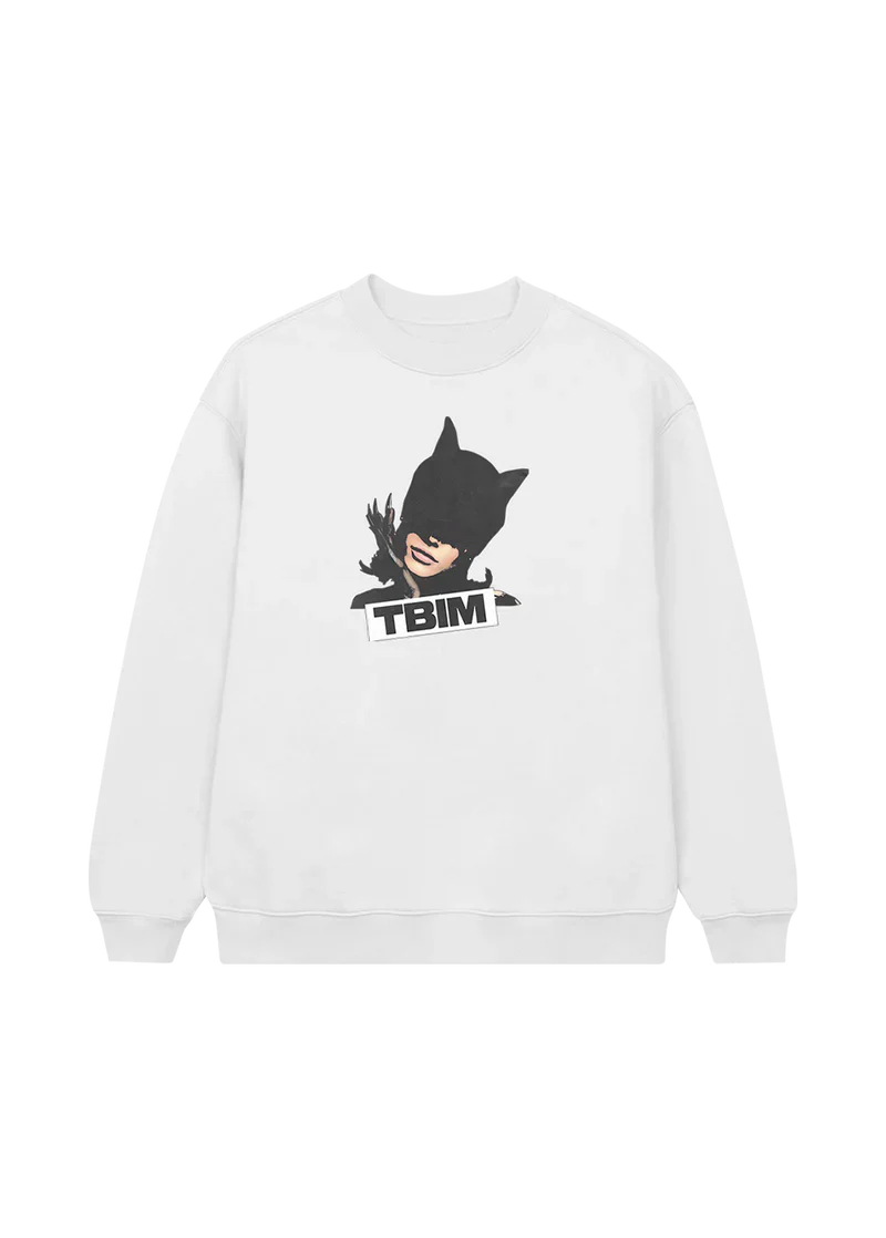 White crewneck sweatshirt featuring a bold graphic of Ariana Grande in a black latex cat mask with claws, paired with the block text “TBIM” — a fierce, stylish tribute to the boy is mine era.

