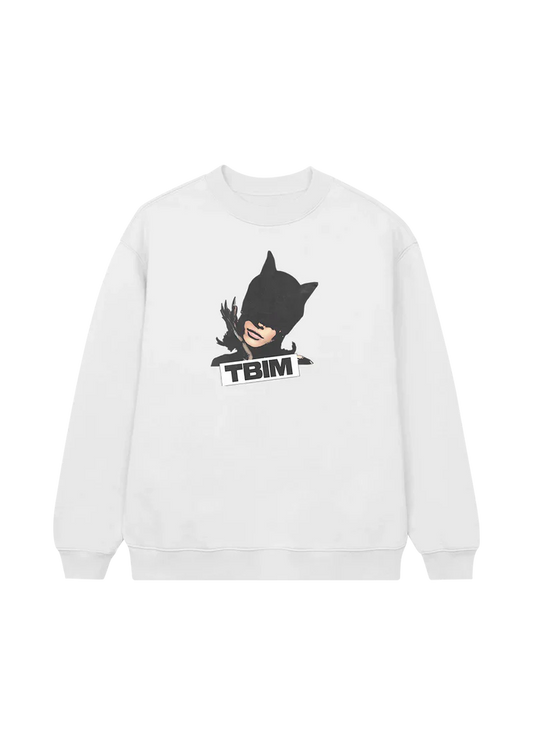White crewneck sweatshirt featuring a bold graphic of Ariana Grande in a black latex cat mask with claws, paired with the block text “TBIM” — a fierce, stylish tribute to the boy is mine era.

